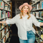 Girl in library with book shelves