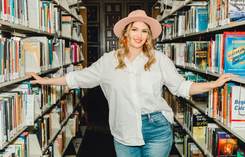 Girl in library with book shelves